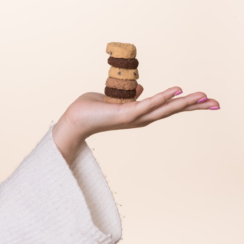 zoom on a female hand holding cookies privacy policy Louise Mila